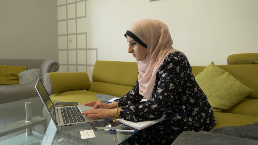 Foto: Eine Frau mit Hijab vor einem Laptop
