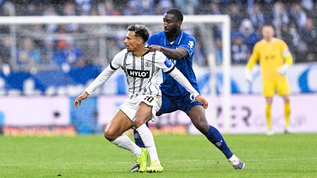 Foto: Bambasé Conté (l, SV 07 Elversberg) und Patric Pfeiffer (SV Darmstadt 98) kämpfen um den Ball.