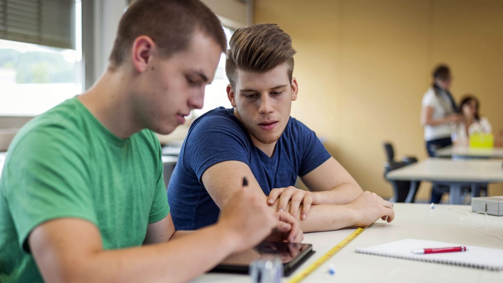 Zwei Schüler arbeiten im Klassenraum an einem Tablet