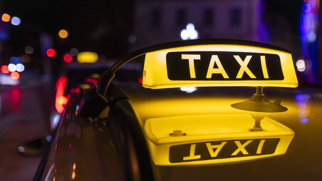 Foto: Leuchtendes Taxi Dachzeichen auf einem Fahrzeugdach bei Nacht