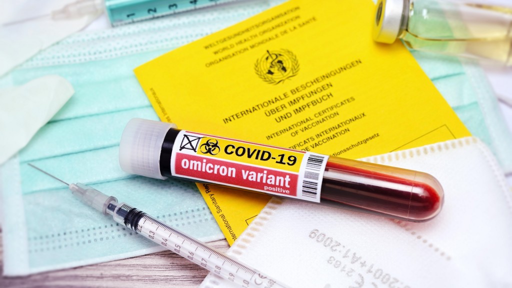 Blutentnahmeröhrchen mit Aufschrift Omicron variant auf Impfpass, Symbolfoto Omikron-Variante B.1.1.529 