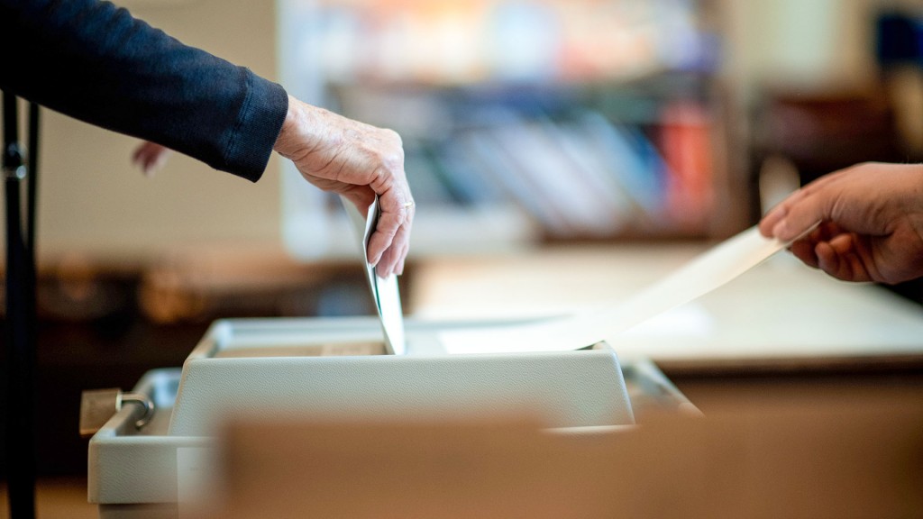 Eine Frau wirft ihren Stimmzettel in ein Wahlurne