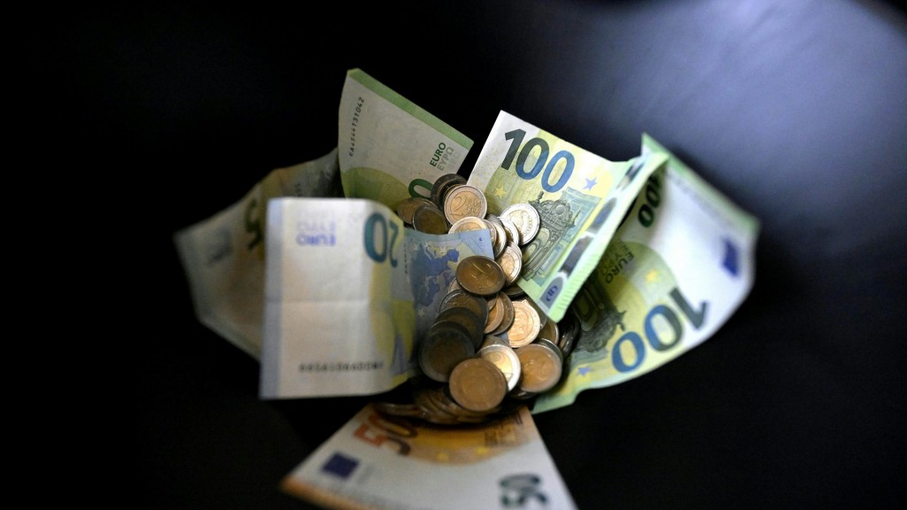 Foto: Münzen und Geldscheine vor einem schwarzen Hintergrund (Symbolbild)