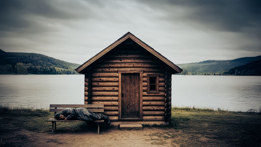 Eine Holzhütte an einem See, davor steht eine Bank, auf der ein Obdachloser schläft.